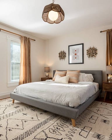 Warm bedroom with linen curtains and king bed